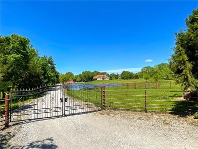 View of gate featuring a rural view and a lawn | Image 2