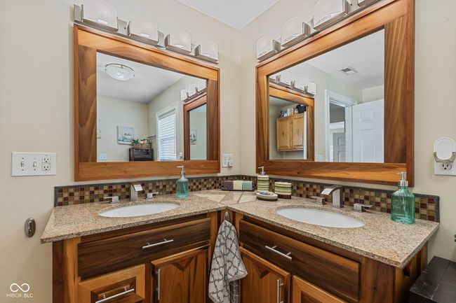 bathroom featuring a sink, decorative backsplash, and double vanity | Image 29