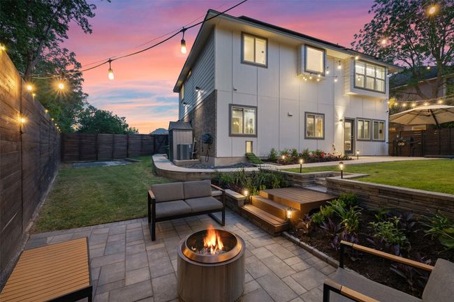 Wrap around back yard is perfect for relaxing on the large patio, tiered yard with sidewalk, privacy fencing and three gates. | Image 28