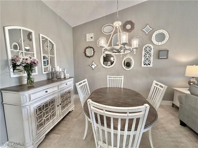 Dining space with a chandelier and vaulted ceiling | Image 4