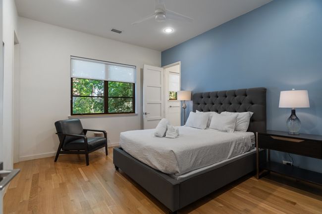 Bedroom with light wood-type flooring, baseboards, a ceiling fan, and recessed lighting | Image 23