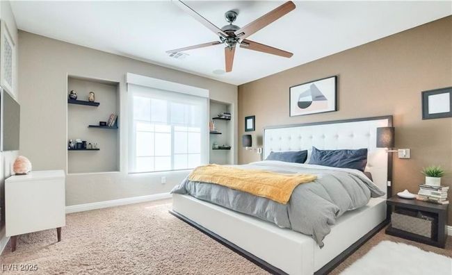 Bedroom with carpet floors, baseboards, and ceiling fan | Image 8