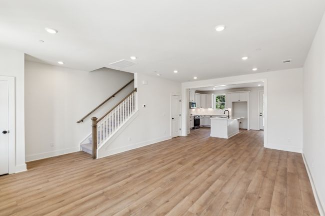 The open layout means you can easily grab a drink in the kitchen without missing the conversations in the living room for game night! Actual photo of home. | Image 9
