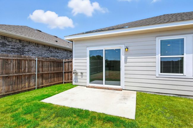 Rear view of property featuring a patio and a shingled roof | Image 20