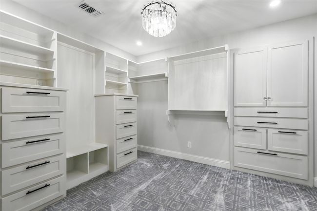 Walk in closet featuring a chandelier and tile patterned floors | Image 26