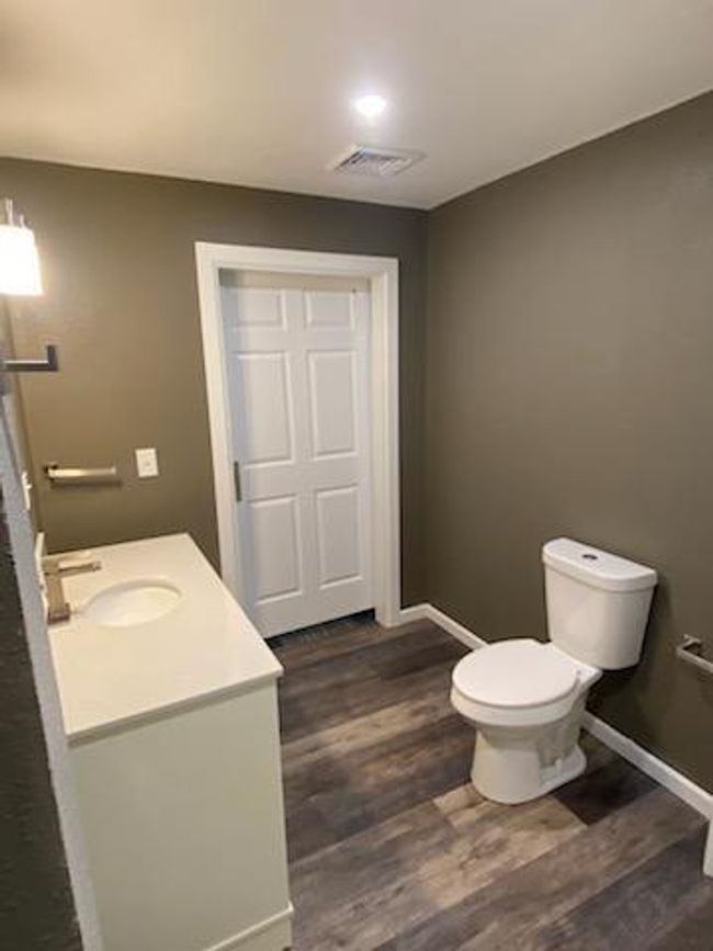 Bathroom with vanity, toilet, and hardwood / wood-style floors | Image 17