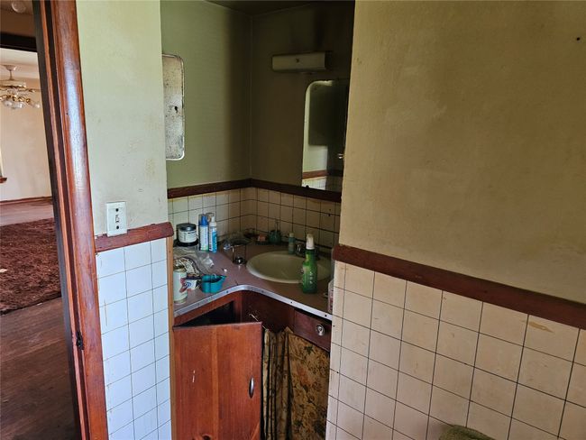 Bathroom with vanity, tasteful backsplash, and tile walls | Image 8