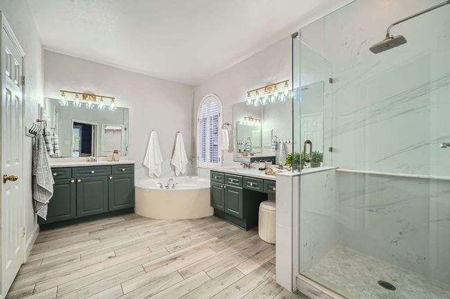 Gorgeously updated bath with quartz countertops, frameless glass shower, designer lighting & hardware | Image 20