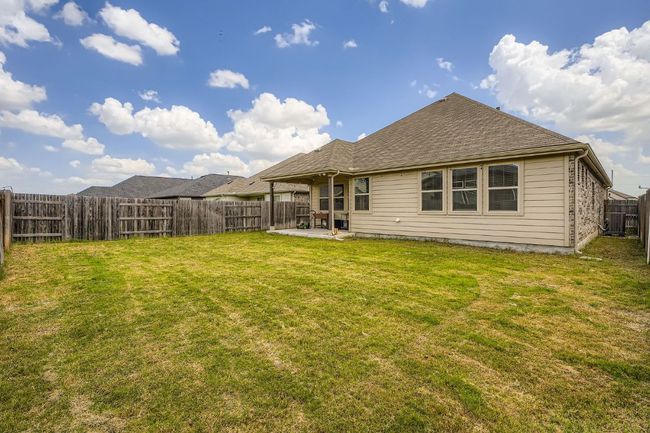 Back of property with a fenced backyard, a patio, and a shingled roof | Image 27