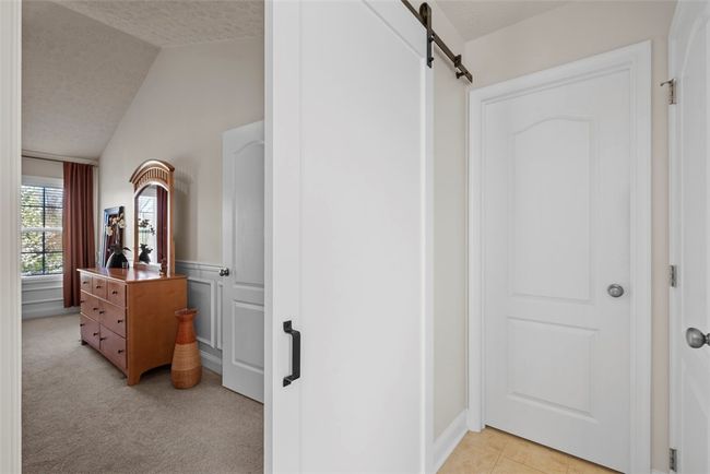 A barn door separates the bathroom from the master bedroom. | Image 29