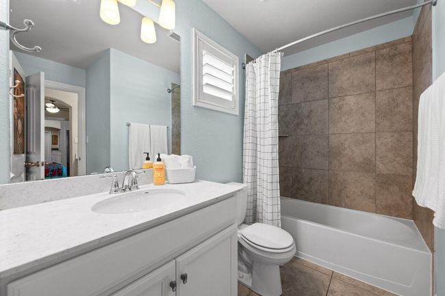 Bathroom with vanity, shower / bath combo with shower curtain, and tile patterned flooring | Image 29