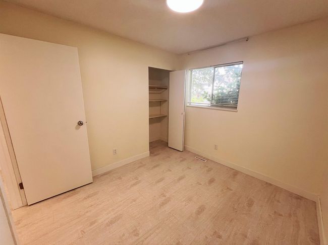 Unfurnished bedroom with light wood-style floors and a closet | Image 7