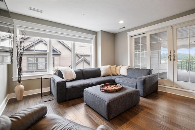 Third floor Family Room with hardwood floor and wet bar! Sliding doors to enormous covered deck with low maintenance floor and railing. | Image 33