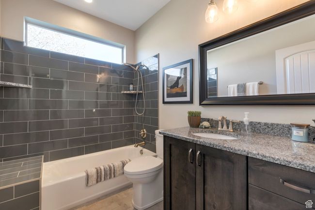 Full bathroom featuring bathing tub / shower combination, vanity, and toilet | Image 30