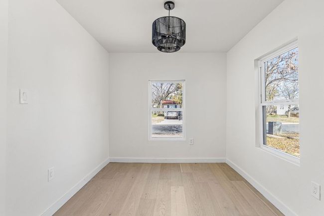 Empty room featuring light wood-type flooring and plenty of natural light | Image 12