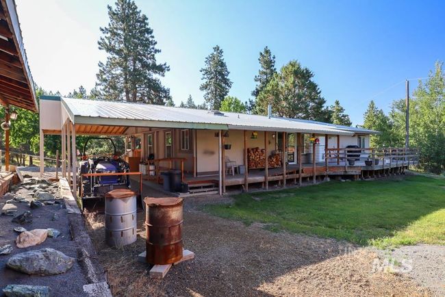 View of front of house with a front lawn and a metal roof | Image 37