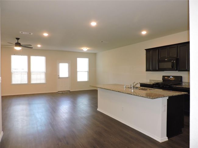 Very open living area, dining and kitchen with access to backyard. | Image 11