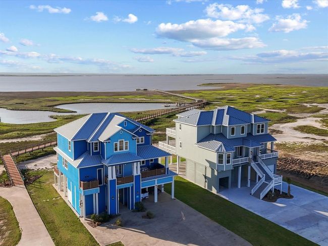 Pictured here: the Gulf Palace (left) and another 5-bedroom Seahorse home (right), both built by Seahorse Homes LLC. 5002 Blue Water Hwy will mirror this luxury and craftsmanship—this time on the beachfront side, with elevated views and stronger ROI potential for short-term rental investors or second-home buyers. | Image 6
