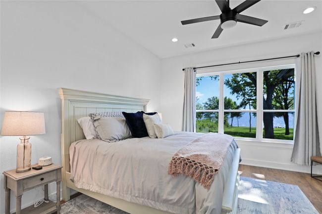 Bedroom with lofted ceiling, wood finished floors, visible vents, and recessed lighting | Image 20