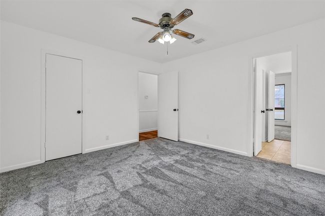 Unfurnished bedroom featuring carpet flooring, baseboards, and ceiling fan | Image 20
