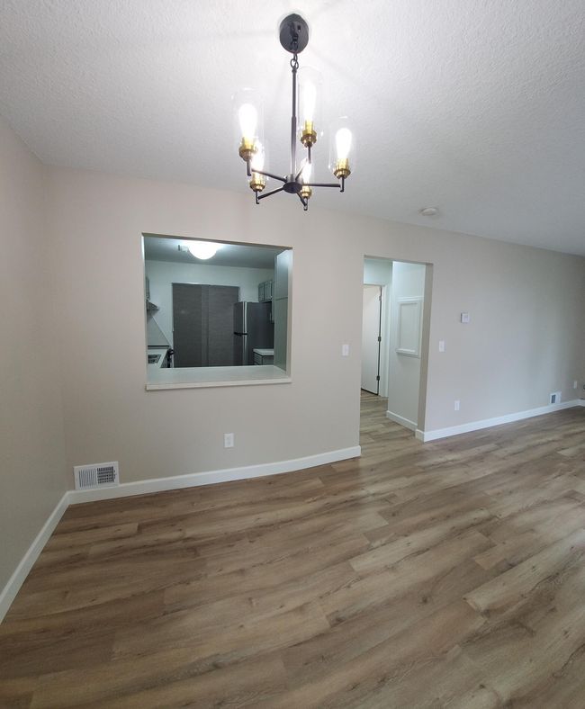 Dining area with pass-through opening from the kitchen. All new flooring through-out the home! Beautiful! Very clean! | Image 5