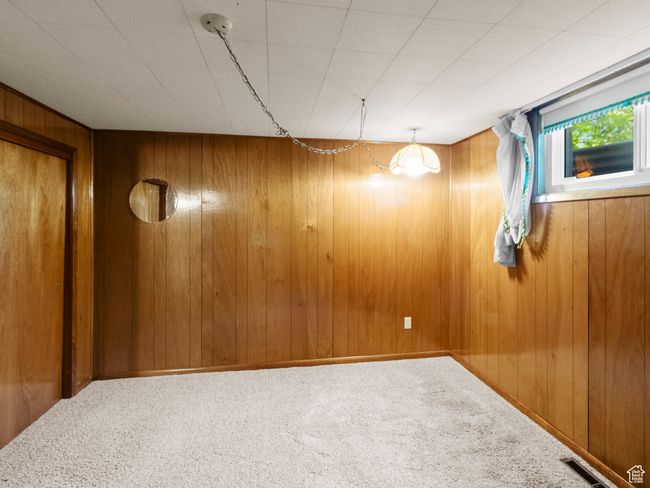 Unfurnished room with carpet flooring and wood paneled walls | Image 27