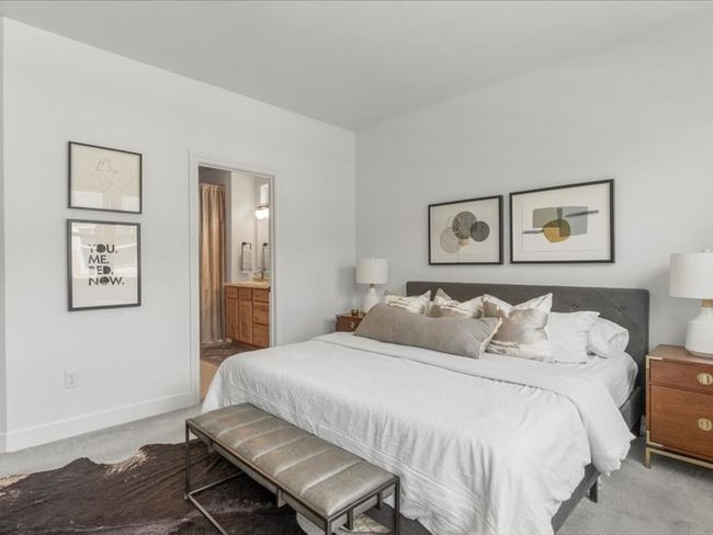 Carpeted bedroom featuring baseboards and ensuite bath | Image 9