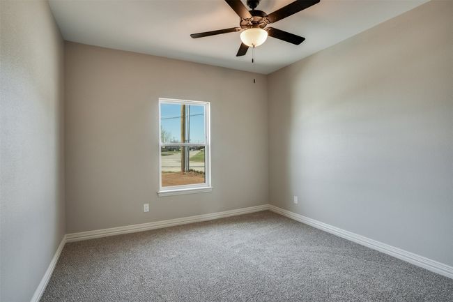 Empty room featuring baseboards, a ceiling fan, and carpet | Image 20