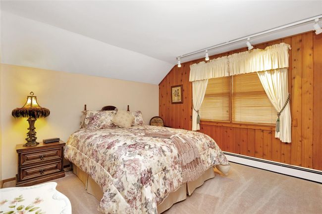 Laundry area featuring washer and clothes dryer, light tile patterned flooring, baseboards, and baseboard heating | Image 24