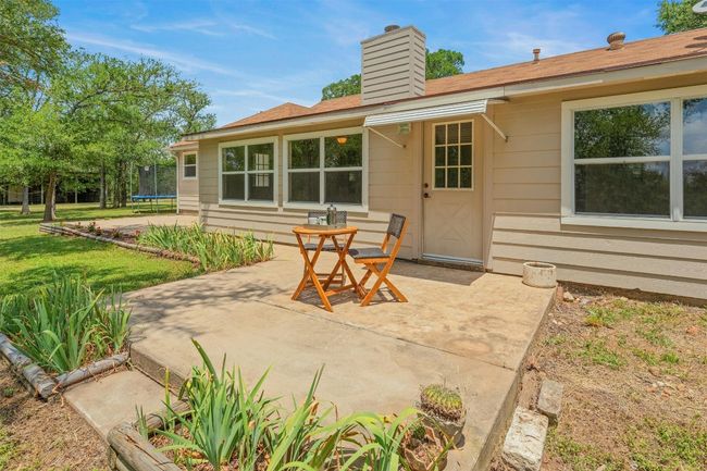 Back porch sitting area with flower beds outlining the porch. | Image 25