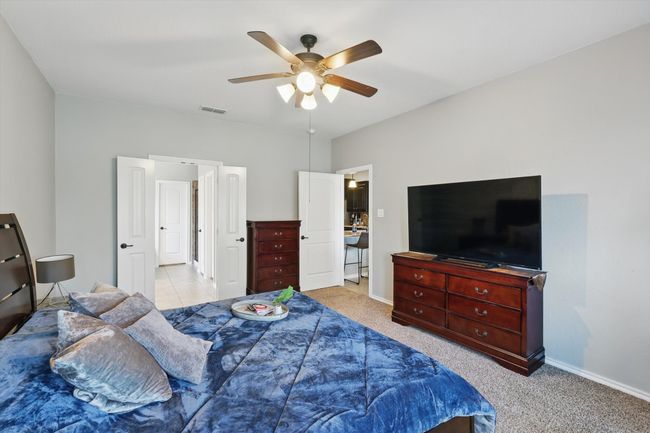 Carpeted bedroom featuring visible vents, baseboards, and a ceiling fan | Image 18