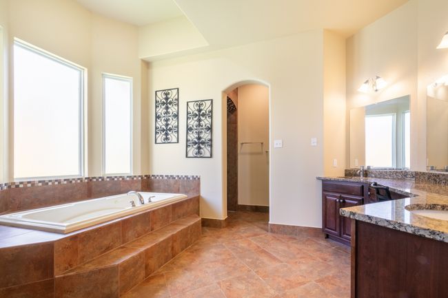 Full bathroom featuring two vanities and a garden tub | Image 17
