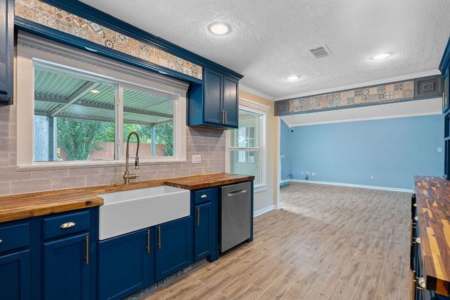 Kitchen flows into living areas. | Image 11