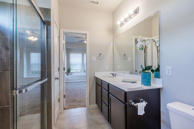 Full bath with visible vents, baseboards, toilet, tile patterned floors, and vanity | Image 28
