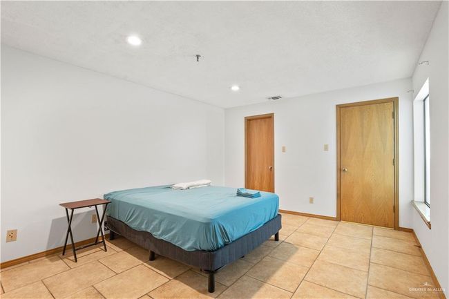Bedroom with recessed lighting and light tile patterned floors | Image 14