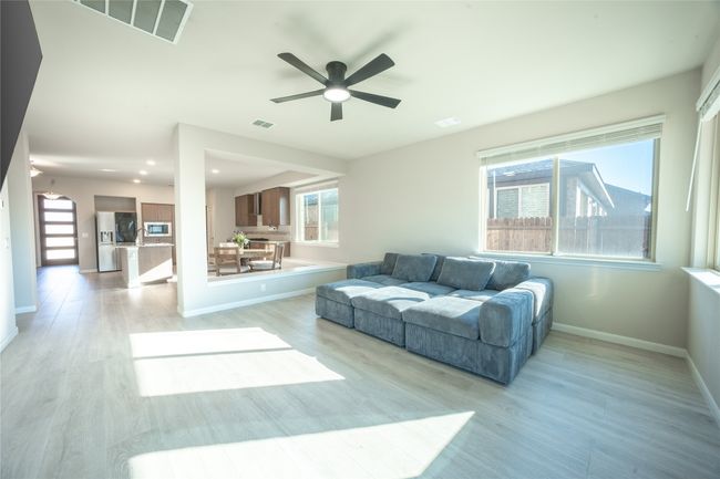 Living room featuring light hardwood / wood-style flooring and ceiling fan | Image 11