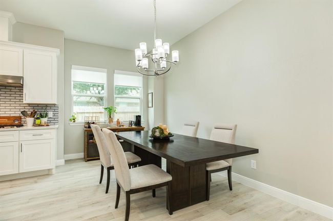 The chandelier is a warm and invitingambiance over the dining space. | Image 11