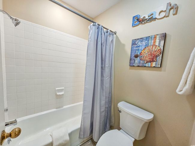 Full bathroom featuring shower / bath combo and toilet | Image 34