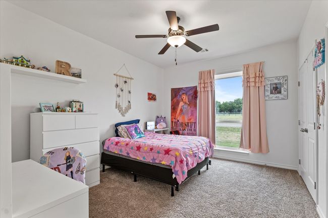 Carpeted bedroom featuring ceiling fan, baseboards, and visible vents | Image 30