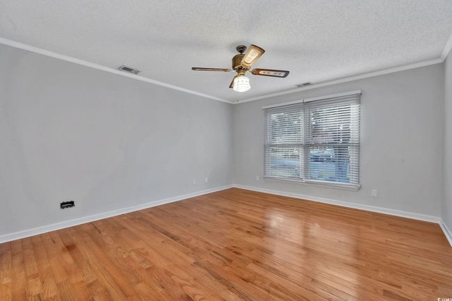 Interior space featuring wood walls, ceiling fan, and hardwood / wood-style flooring | Image 8