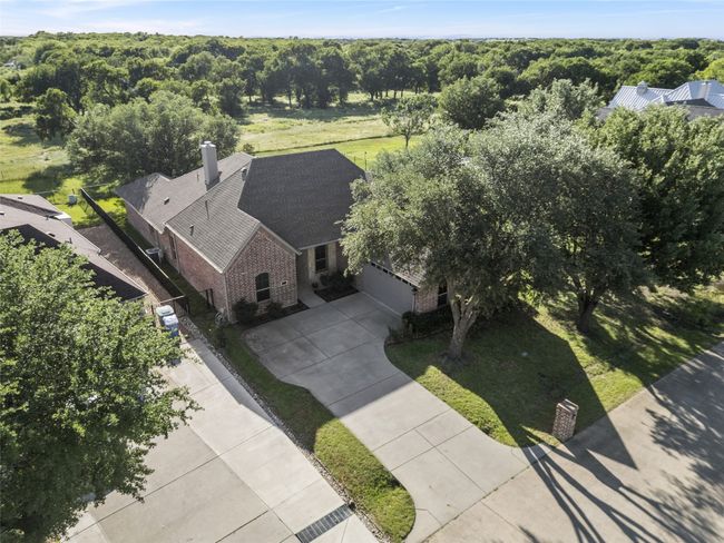 Aerial view of home with good shot of the swing driveway & beautiful trees! | Image 36