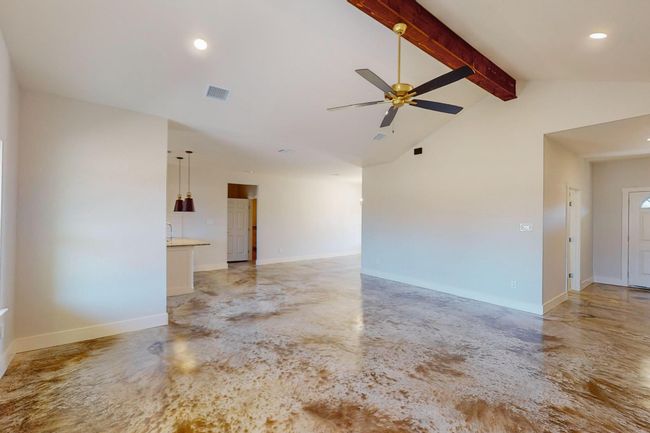 Empty room with concrete floors, a ceiling fan, and recessed lighting | Image 11