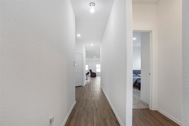 Hall with baseboards, recessed lighting, and dark wood-type flooring | Image 5