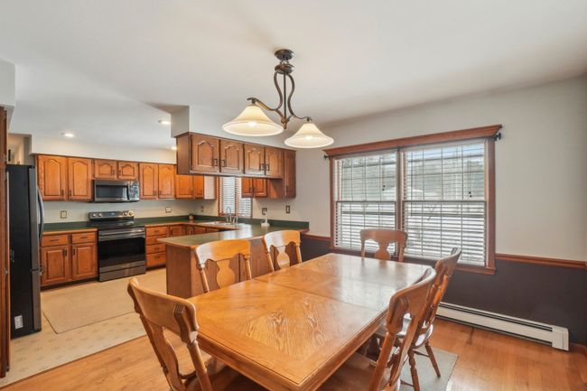Spacious eating area open to kitchen. | Image 7