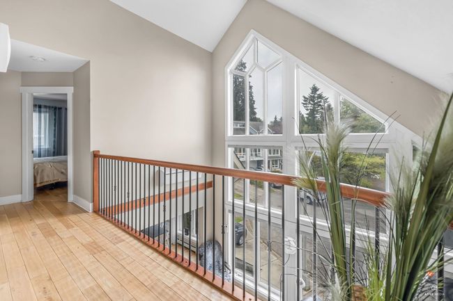 Hall featuring hardwood / wood-style floors, lofted ceiling, and baseboards | Image 20