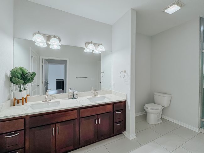 Full bath with new tile flooring and double vanity. | Image 16