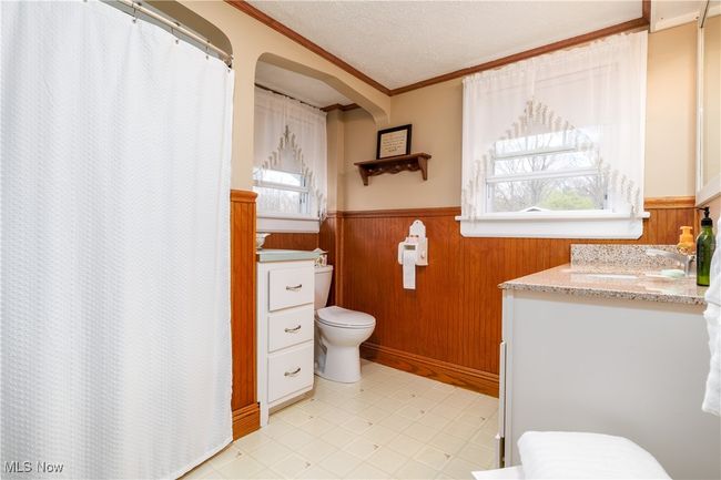 Bathroom with wainscoting, vanity, ornamental molding, and toilet | Image 22