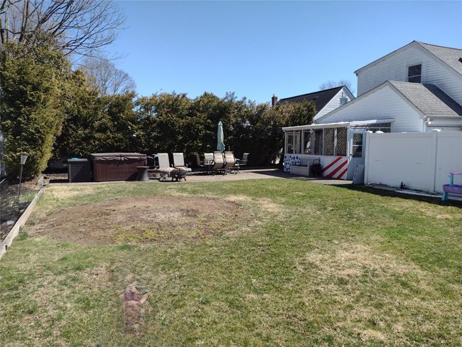 View of yard with a patio, fence, a sunroom, and a hot tub | Image 6