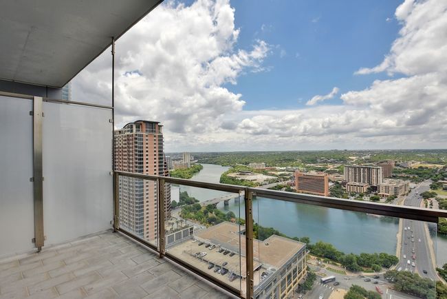 Balcony featuring a city view and a water view | Image 18