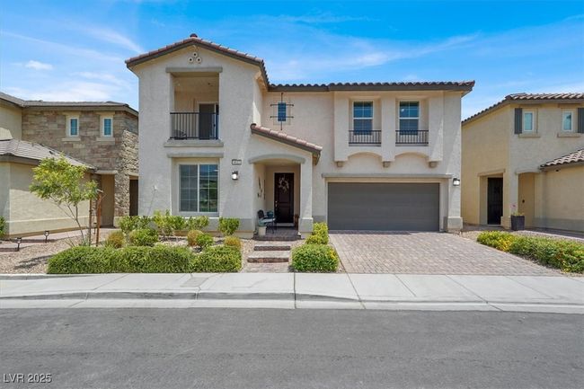 Mediterranean / spanish house featuring a balcony, decorative driveway, stucco siding, and a tiled roof | Image 5